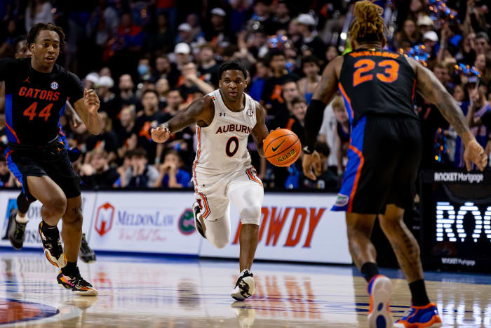Feb 19, 2022; Gainesville, Florida, USA; Auburn Tigers guard K.D. Johnson (0) dribbles the ball during the first half against the Florida Gators at Billy Donovan Court at Exactech Arena. Mandatory Credit: Matt Pendleton-USA TODAY Sports
