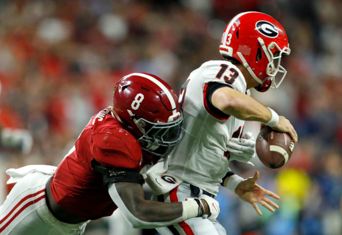 Alabama Crimson Tide linebacker Christian Harris (8) fumbles Georgia Bulldogs quarterback Stetson Bennett (13) and returns the ball Monday, Jan. 10, 2022, during the College Football Playoff National Championship at Lucas Oil Stadium in Indianapolis.