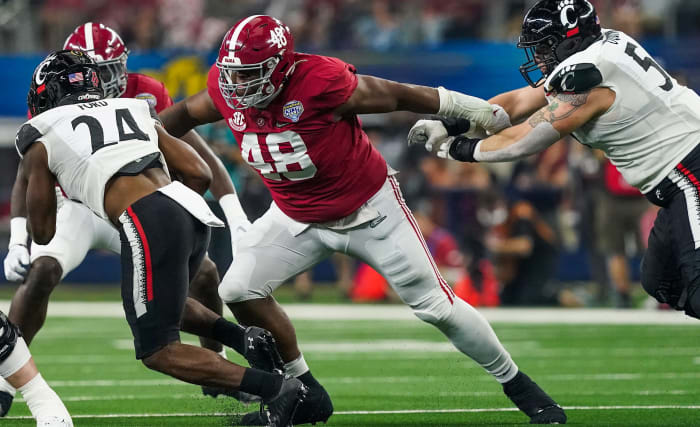 Alabama defensive lineman Phidarian Mathis (48) tackles Cincinnati running back Jerome Ford (24) in the 2021 College Football Playoff Semifinal game at the 86th Cotton Bowl at AT&T Stadium in Arlington, Texas Friday, Dec.  31, 2021.