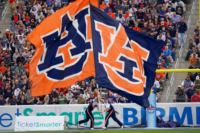 Dec 28, 2021;  Birmingham, Alabama, USA;  Auburn Tigers cheerleaders let the flags wave after a score against Houston Cougars during the second half of the 2021 Birmingham Bowl at Protective Stadium.  Mandatory Credit: Marvin Gentry-USA TODAY Sports