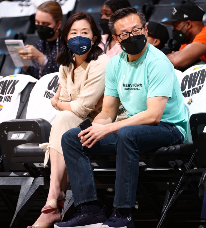 Clara Wu Tsai and Joe Tsai sitting courtside at a New York Liberty game
