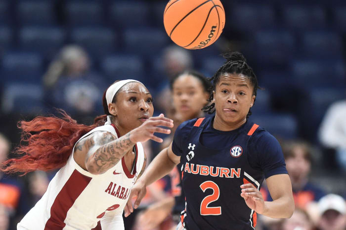 Alabama guard JaMya Mingo-Young (2) and Auburn guard Sania Wells (2) scramble after the ball during the SEC Women's Basketball Tournament game in Nashville, Tenn. on Wednesday, March 2, 2022.