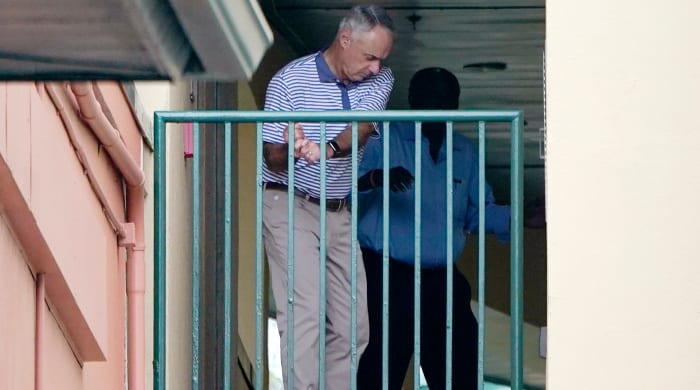 Major League Baseball commissioner Rob Manfred practices his golf swing as negotiations continue with the players' association for a labor agreement, Tuesday, March 1, 2022, at Roger Dean Stadium in Jupiter , in Florida.