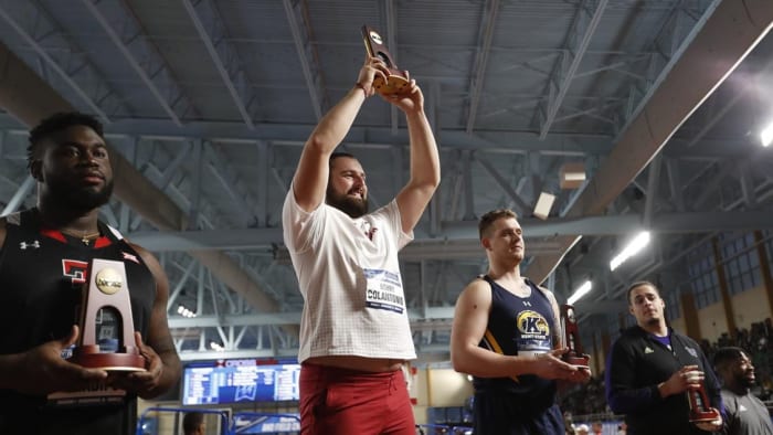 Bobby Colantonio Jr. holds up his national championship trophy in the weight throw at the 2022 NCAA Indoor Track & Field Championships at Birmingham, Ala.