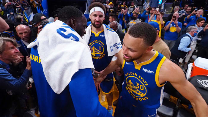 Golden State Warriors forward Draymond Green (23), guard Klay Thompson (11) and guard Stephen Curry (30) celebrate after the game against the Washington Wizards.