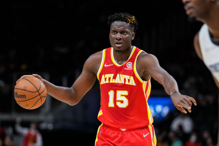 Atlanta Hawks center Clint Capela points to a teammate while dribbling.