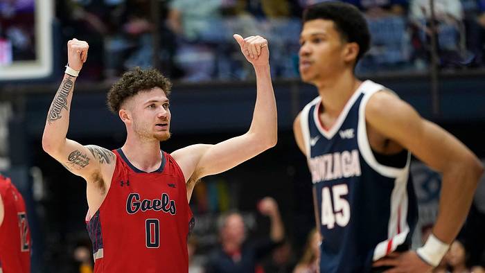 Saint Mary’s Logan Johnson lifts his arms in celebration vs Gonzaga