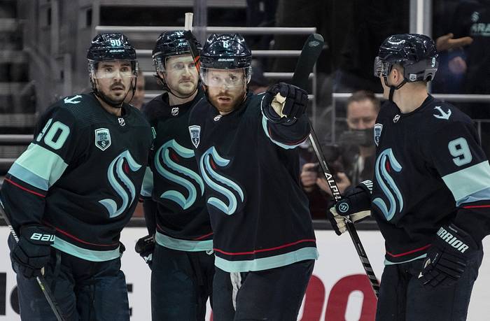 Mar 19, 2022; Seattle, Washington, USA; Seattle Kraken defenseman Adam Larsson (6) celebrates with forward Marcus Johansson (90) and forward Jared McCann (16) and forward Ryan Donato (9) after a goal against the Detroit Red Wings during the third period at Climate Pledge Arena. Mandatory Credit: Stephen Brashear-USA TODAY Sports