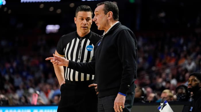 Duke head coach Mike Krzyzewski, right, talks with a referee during the first half of a college basketball game against Michigan State in the second round of the NCAA tournament Sunday, March 20, 2022, in Greenville, S.C.