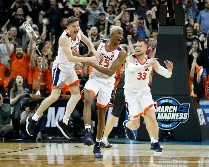 Virginia Cavaliers forward Mamadi Diakite (25), Kyle Guy (5) and Jack Salt (33) celebrate following of their NCAA Division I Basketball Championship "Elite 8" basketball game at the KFC Yum!  Center in Louisville, KY., on Saturday, Mar 30, 2019. The Virginia Cavaliers defeated the Purdue Boilermakers 80-75.