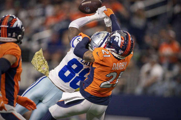 Denver Broncos cornerback Ronald Darby (21) breaks a pass assigned to Dallas Cowboys wide receiver CeeDee Lamb (88) during the second half at AT&T Stadium.