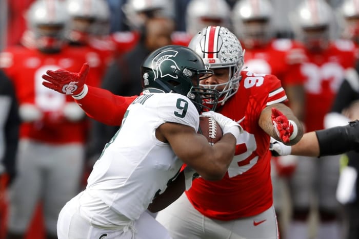 Michigan State running back Kenneth Walker III (9) tackled by Ohio State defensive tackle Haskell Garrett (92). Mandatory Credit: Joseph Maiorana-USA TODAY Sports
