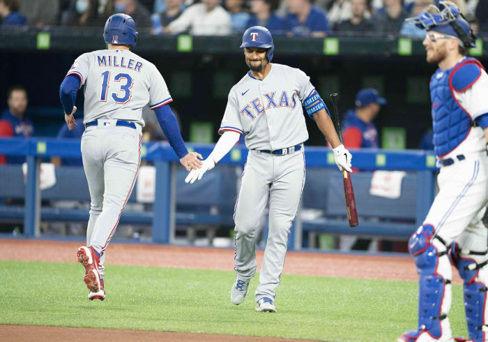 Apr 8, 2022; Toronto, Ontario, CAN; Texas Rangers left fielder Brad Miller (13) celebrates hitting a home run with second baseman Marcus Semien (2) during the first inning against the Toronto Blue Jays at Rogers Centre . Mandatory Credit: Nick Turchiaro-USA TODAY Sports