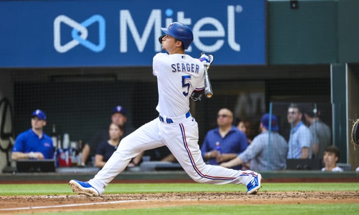 Apr 11, 2022; Arlington, Texas, USA; Texas Rangers shortstop Corey Seager (5) singles during the fifth inning against the Colorado Rockies at Globe Life Field. Mandatory Credit: Kevin Jairaj-USA TODAY Sports