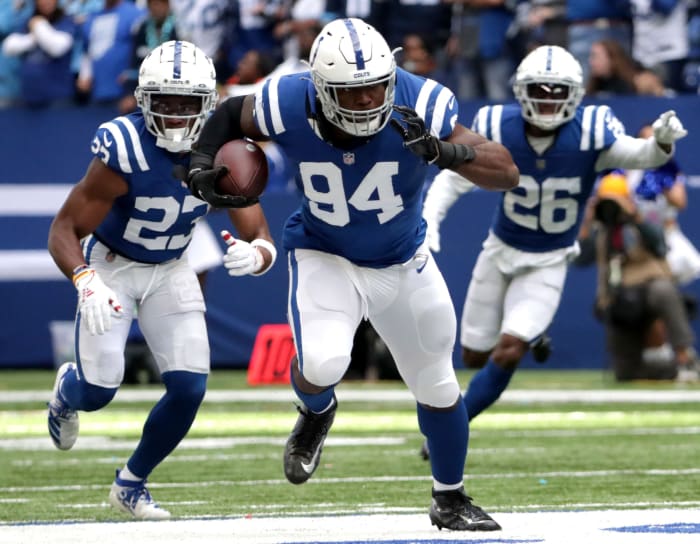 Indianapolis Colts defensive end Tyquan Lewis (94) rushes the ball after making an interception Sunday, Oct. 31, 2021, during a game against the Tennessee Titans at Lucas Oil Stadium in Indianapolis.