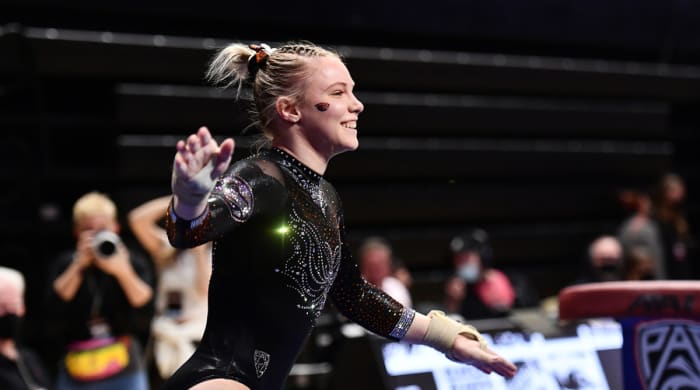 Jade Carey smiles after completing a routine at a gymnastics competition at Oregon State.