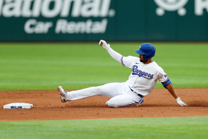 Apr 16, 2022; Arlington, Texas, USA; Texas Rangers second baseman Marcus Semien (2) doubles to drive in a run against the Los Angeles Angels during the third inning at Globe Life Field. Mandatory Credit: Andrew Dieb-USA TODAY Sports