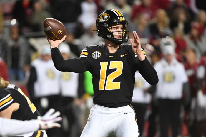 Missouri quarterback Brady Cook (12) throws the ball during an NCAA college football game against Arkansas on Friday, November 26, 2021 in Fayetteville, Arkansas (AP Photo/Michael Woods)