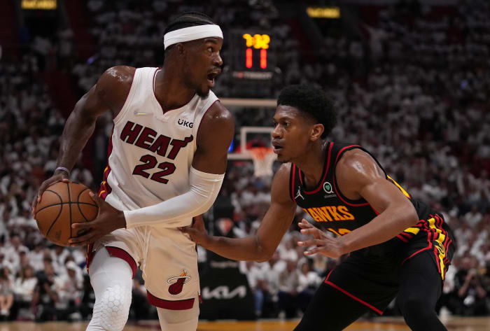 April 19, 2022;  Miami, FL, USA;  Miami Heat forward Jimmy Butler (22) controls the ball around Atlanta Hawks forward De'Andre Hunter (12) during the first half of game two of the first round of the 2022 NBA Playoffs at FTX Arena.
