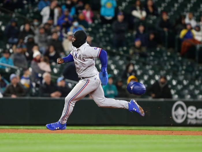 Apr 21, 2022; Seattle, Washington, USA; Texas Rangers right fielder Adolis Garcia (53) rounds the bases to score on a double by Texas Rangers right fielder Kole Calhoun (56) during the ninth inning against the Seattle Mariners at T-Mobile Park. Mandatory Credit: Lindsey Wasson-USA TODAY Sports