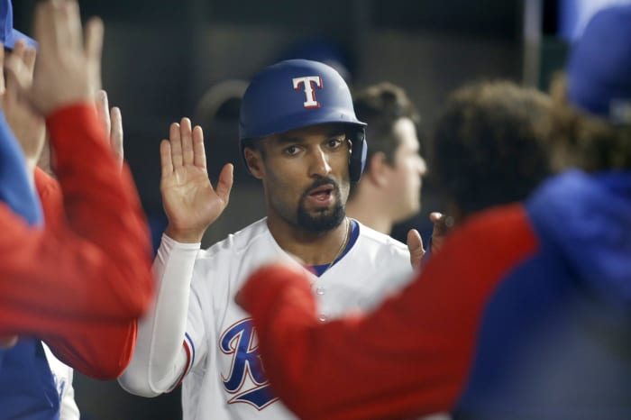 Apr 25, 2022; Arlington, Texas, USA; Texas Rangers second baseman Marcus Semien (2) is congratulated after scoring a run in the seventh inning against the Houston Astros at Globe Life Field. Mandatory Credit: Tim Heitman-USA TODAY Sports