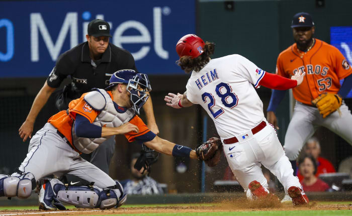 Apr 27, 2022;  Arlington, Texas, USA;  Houston Astros catcher Jason Castro (18) tags out Texas Rangers catcher Jonah Heim (28) at home plate during the second inning at Globe Life Field.  Mandatory Credit: Kevin Jairaj-USA TODAY Sports