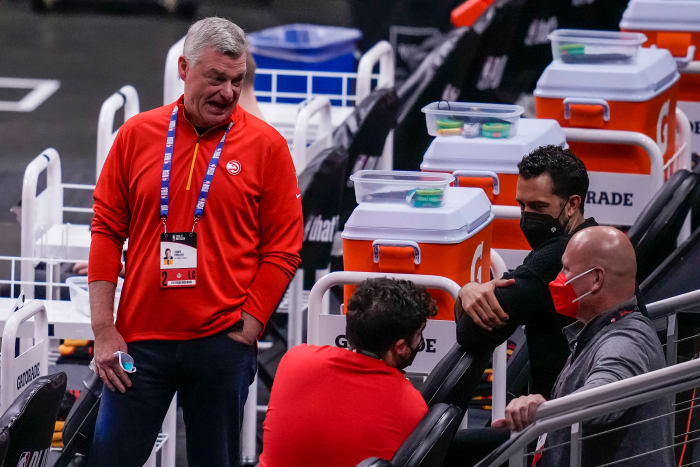 Atlanta Hawks team owner Antony Ressler (left in red) talks to Hawks general manager Travis Schlenk far right prior to the game against the Philadelphia 76ers before game three in the second round of the 2021 NBA Playoffs at State Farm Arena.