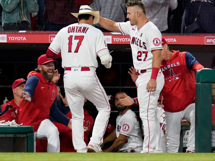 Los Angeles Angels center fielder Mike Trout (27) places a cowboy hat on the head of designated hitter Shohei Ohtani (17) after Ohtani hit a home run during the sixth inning of a baseball game against the Tampa Bay Rays in Anaheim, Calif., Monday, May 9, 2022.