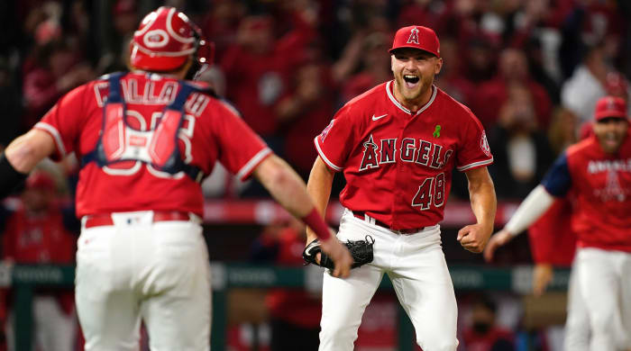 Los Angeles Angels starting pitcher Reid Detmers (48) celebrates with catcher Chad Wallach (35) after throwing a hitter against the Tampa Bay Rays at Angel Stadium.