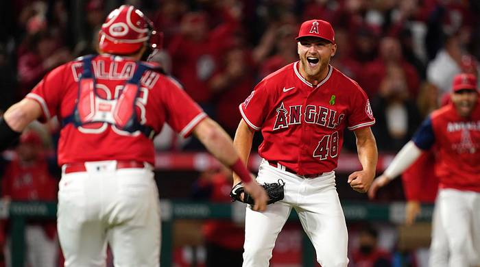 Los Angeles Angels starting pitcher Reid Detmers (48) celebrates with catcher Chad Wallach (35) after throwing a no hitter against the Tampa Bay Rays at Angel Stadium.
