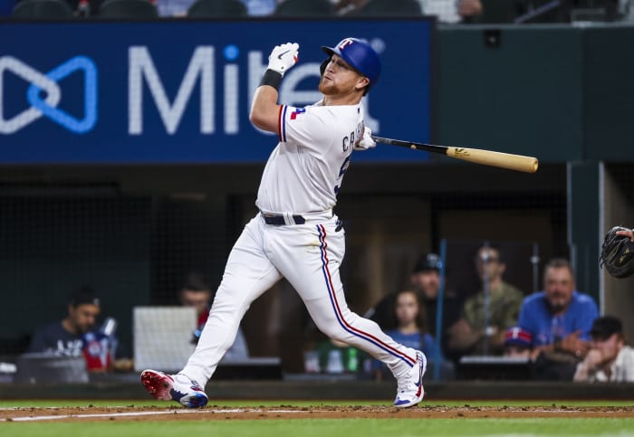 May 12, 2022; Arlington, Texas, USA; Texas Rangers right fielder Kole Calhoun (56) hits an rbi single during the first inning against the Kansas City Royals at Globe Life Field.