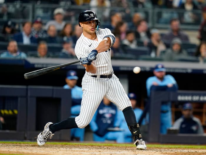The New York Yankees' Giancarlo Stanton hits a three-run home run during the sixth inning of a baseball game against the Toronto Blue Jays, Tuesday, May 10, 2022, in New York.