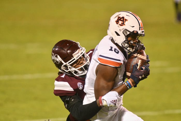 Dec 12, 2020;  Starkville, Mississippi, USA;  Auburn Tigers wide receiver Seth Williams (18) makes a catch for a touchdown while being defended by Mississippi State Bulldogs cornerback Martin Emerson (1) during the fourth quarter at Davis Wade Stadium at Scott Field.