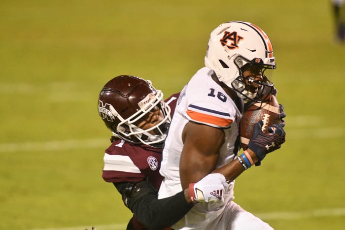 Dec 12, 2020; Starkville, Mississippi, USA; Auburn Tigers wide receiver Seth Williams (18) makes a catch for a touchdown while being defended by Mississippi State Bulldogs cornerback Martin Emerson (1) during the fourth quarter at Davis Wade Stadium at Scott Field.