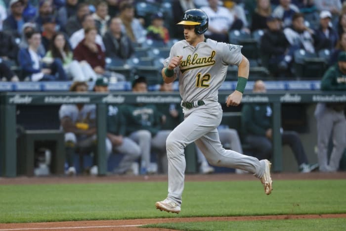 May 23, 2022; Seattle, Washington, USA; Oakland Athletics catcher Sean Murphy (12) scores a run on a sacrifice fly against the Seattle Mariners during the fourth inning at T-Mobile Park. Mandatory Credit: Joe Nicholson-USA TODAY Sports