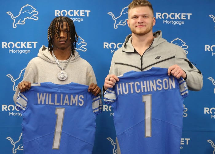 Detroit Lions first round picks receiver Jameson Williams and defensive end Aidan Hutchinson hold up their Lions jerseys during the press conference Friday, April 29, 2022 at the Detroit Lions practice facility in Allen Park.