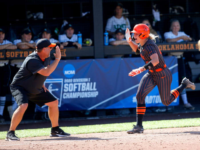 Oregon State softball’s Miranda Elish celebrates her home run with coach Kenny Gajewski