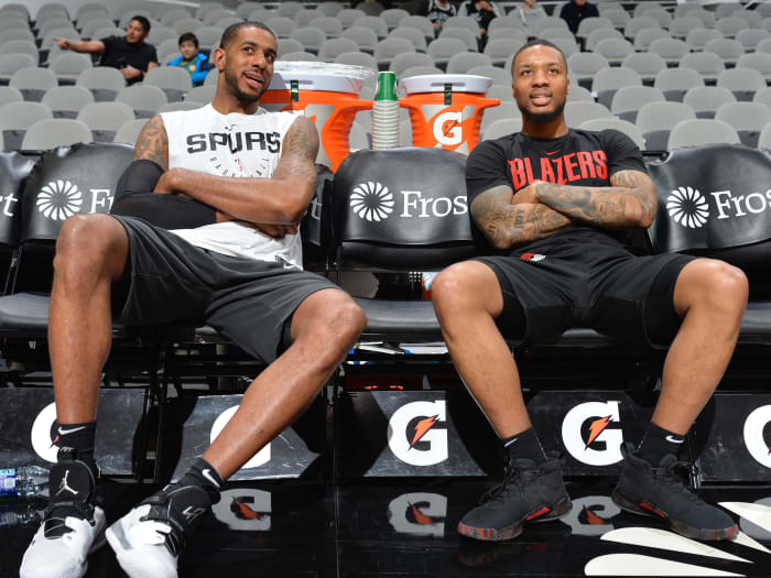 LaMarcus Aldridge #12 of the San Antonio Spurs and Damian Lillard #0 of the Portland Trail Blazers talks before the game on March 16, 2019 at the AT&T Center in San Antonio.