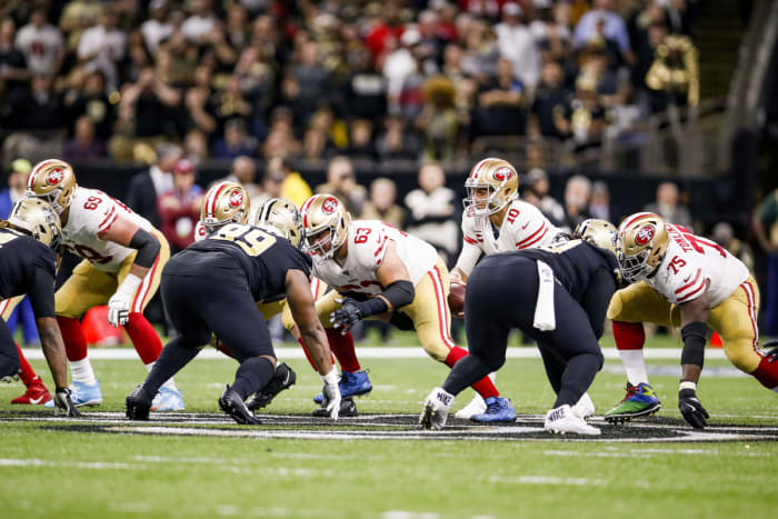 The 49ers' offensive line at the snap in a game against the Saints