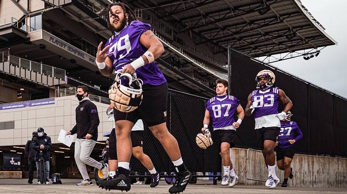 Vic Curne (79) hustles to Husky practice.