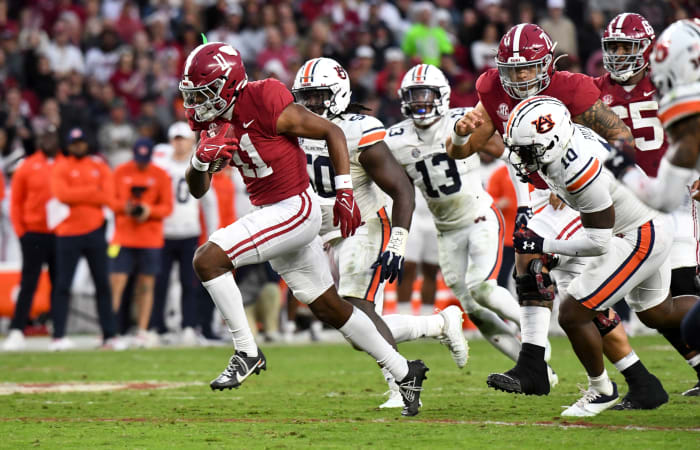 11/26/2022;  Tuscaloosa, Alabama, USA;  Alabama wide receiver Traeshon Holden (11) breaks away from Auburn defenders including Auburn safety Zion Puckett (10) and Auburn defense lineman Marcus Harris (50) on his way to a touchdown at Bryant-Denny Stadium.  Mandatory Credit: Gary Cosby Jr.-USA TODAY Sports