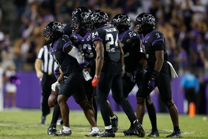 TCU Horned Frog football players react in a group after an interception against the Kansas State Wildcats
