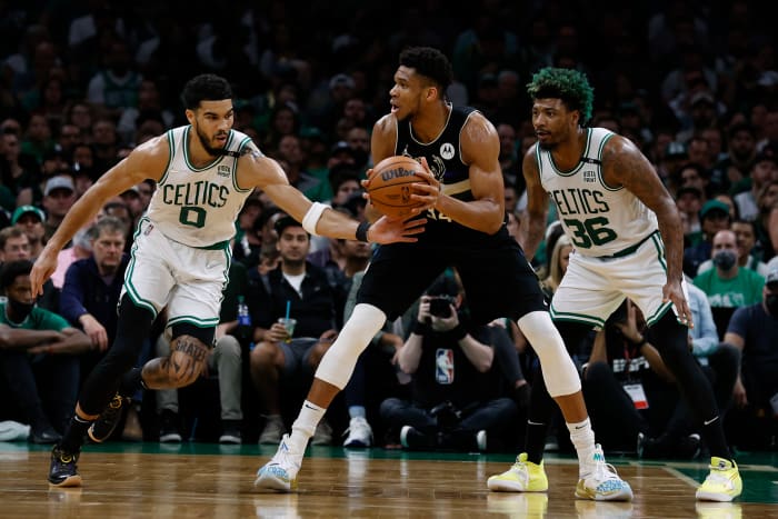 Boston Celtics forward Jayson Tatum (0) attempts to steal the ball from Milwaukee Bucks forward Giannis Antetokounmpo