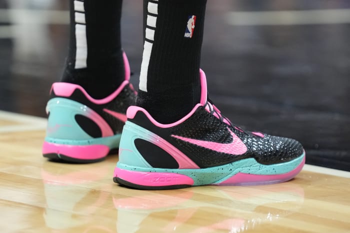 View of black, pink, and teal Nike Kobe shoes.