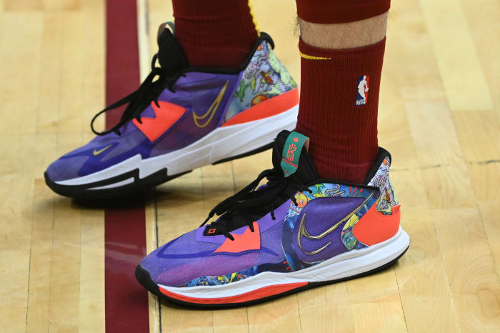 View of purple and orange Nike Kyrie shoes.