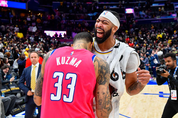 Los Angeles Lakers forward Anthony Davis reacts with Washington Wizards forward Kyle Kuzma after the game at Capital One Arena.
