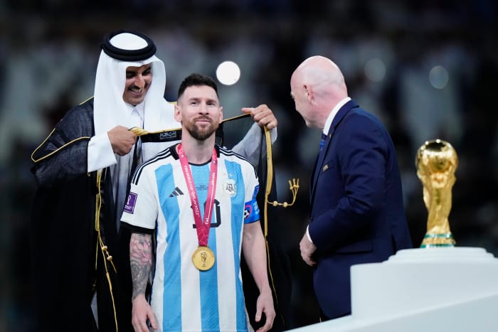 Lionel Messi pictured being dressed in a traditional Arab bisht before he lifted the World Cup trophy as captain of Argentina