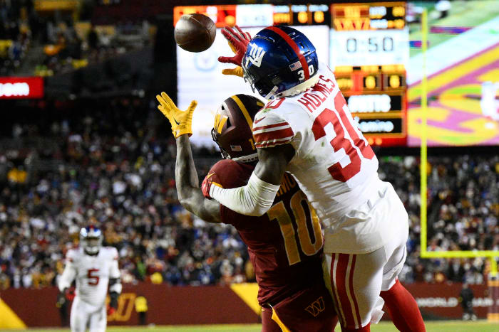 New York Giants cornerback Darnay Holmes (30) defends Washington Commanders wide receiver Curtis Samuel (10) on fourth down to seal a 20-12 victory, Sunday, Dec. 18, 2022, in Landover, Md.