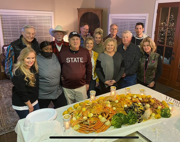 Mike Leach and friends pose for a photo with Starkville restaurant owner Shan Suber at a catering event at his home.