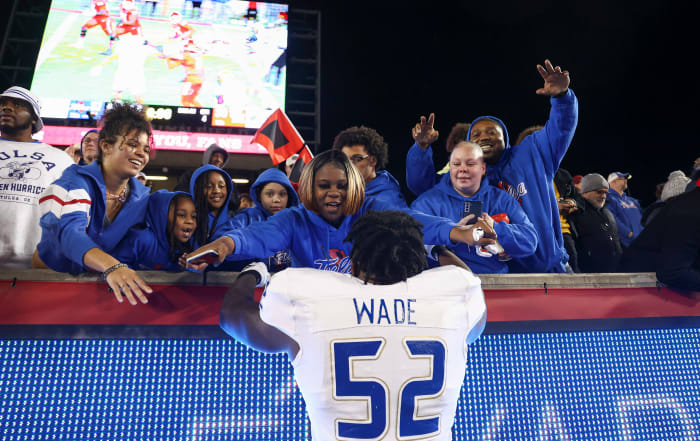 Nov 26, 2022; Houston, Texas, USA; Tulsa Golden Hurricane offensive lineman Dillon Wade (52) celebrates with fans after the game against the Houston Cougars at TDECU Stadium. Mandatory Credit: Troy Taormina-USA TODAY Sports